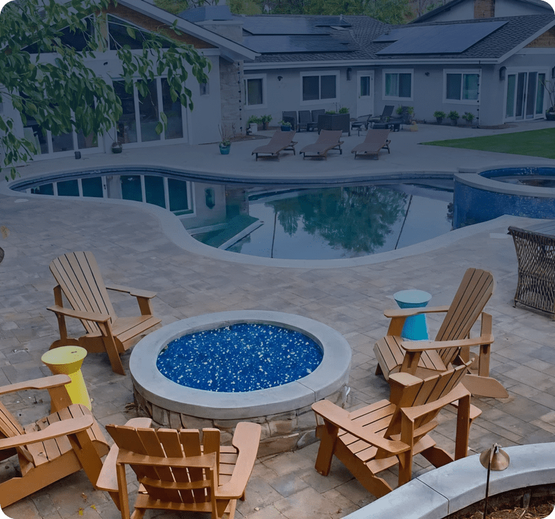 Poolside patio with wooden chairs