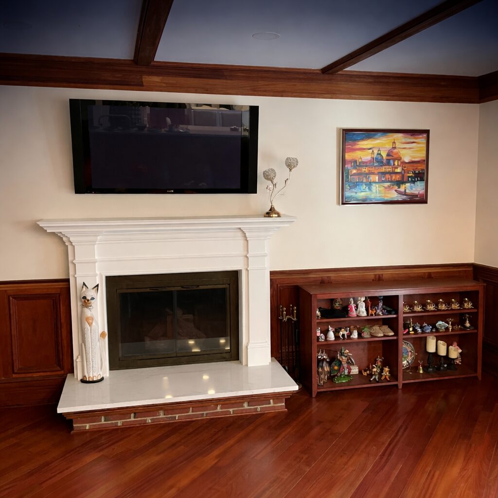 Elegant living room with a marble fireplace and mounted TV.