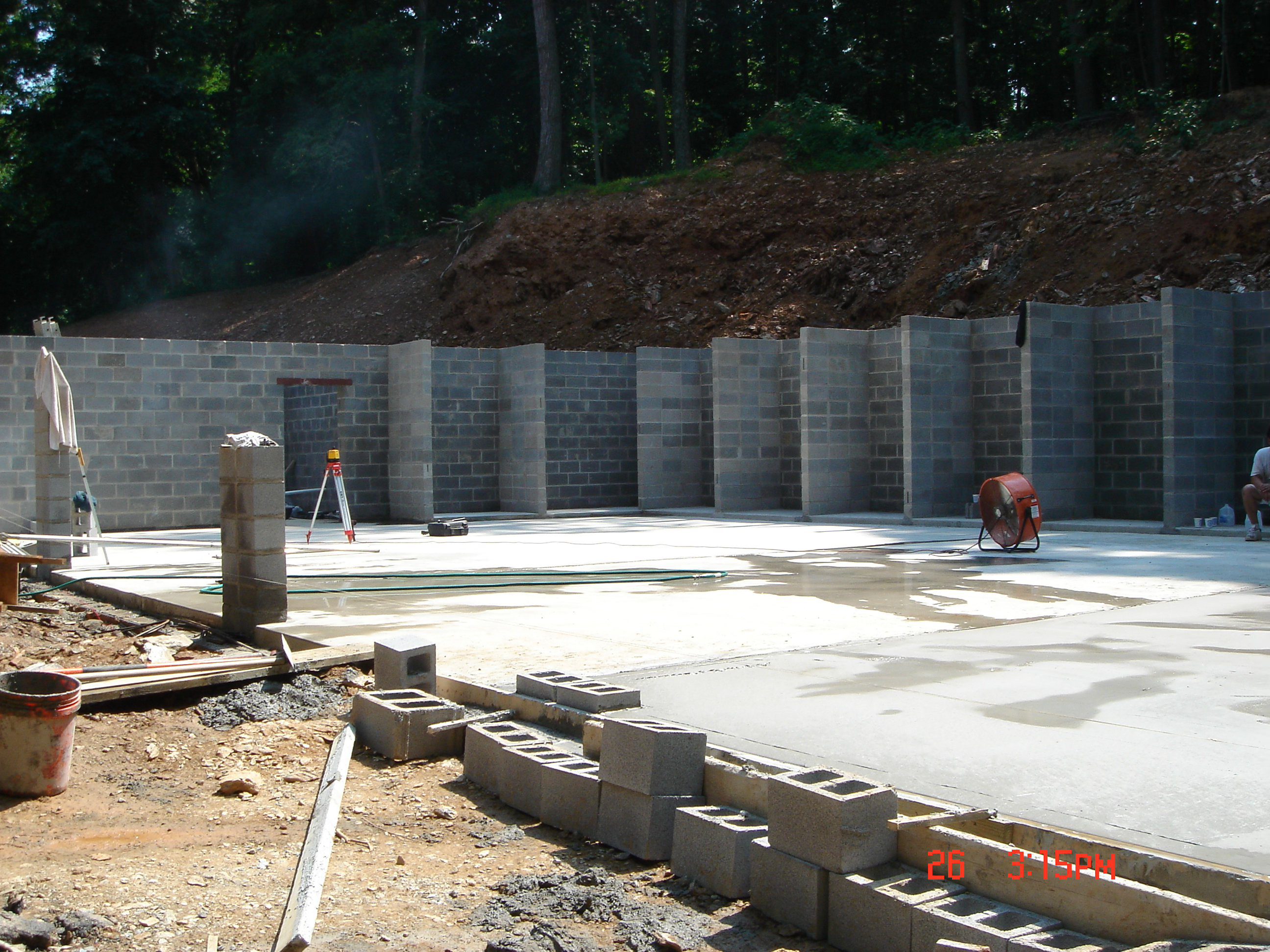 Construction site with concrete foundation and retaining walls.